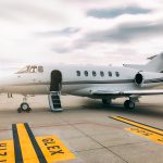 Private luxury jet at the airport terminal runway